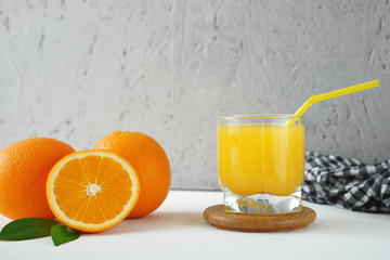 glass of orange juice and oranges