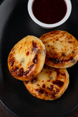 Close up of yummy traditional russian cottage cheese fritters with jam
