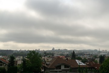 Sunrise and sunset, beautiful clouds over the meadow, hills and buildings in the town. Slovakia