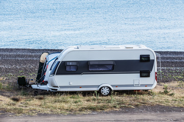 Camper trailer by the sea near the lagoon