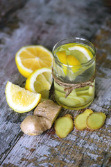 Selective focus. Ginger lemon drink. Ginger water with lemon. Fresh ginger and lemon. Immune enhancing vitamin tea with lemon and ginger.