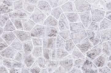 Cobbled stone road detail. Floor of a street with stone tiles. Artistic concrete or stone floor texture for background