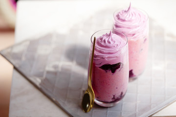 Top view of berry milk shake on grey background