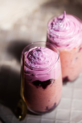 Top view of berry milk shake on grey background