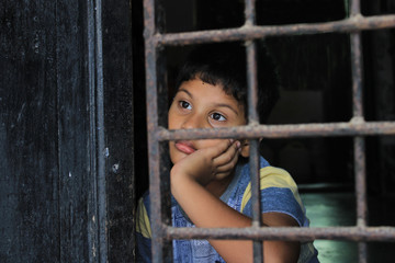 Child is looking at the Future. Child Portrait in front of window. Close-up of child eye looking...