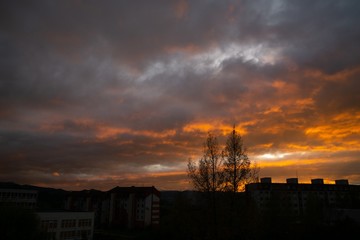 Sunrise and sunset, beautiful clouds over the meadow, hills and buildings in the town. Slovakia