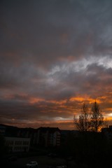 Sunrise and sunset, beautiful clouds over the meadow, hills and buildings in the town. Slovakia