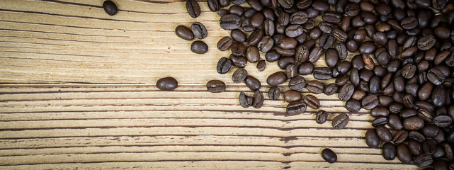 Banner fresh coffee beans on  wooden table background.
