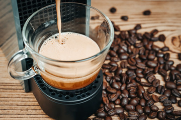 Espresso coffee maker on a wooden table.
