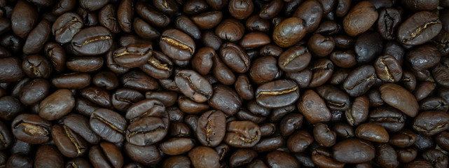 Banner fresh coffee beans on  wooden table background.