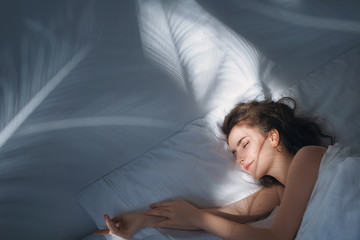 Stock photo -  Girl under the covers in her bed