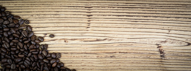 Banner fresh coffee beans on  wooden table background.
