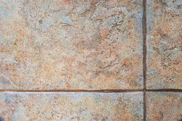 Texture of rough floor tiles with seams as background