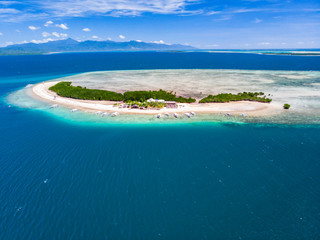 Aerial view of tropical island surrounded by turquoise water