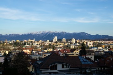 Sunrise and sunset, beautiful clouds over the meadow, hills and buildings in the town. Slovakia