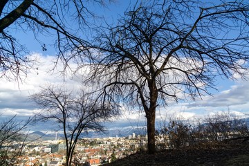 Sunrise and sunset, beautiful clouds over the meadow, hills and buildings in the town. Slovakia