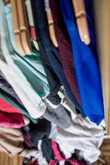 clothes weigh on the shoulders in the closet. Second hand