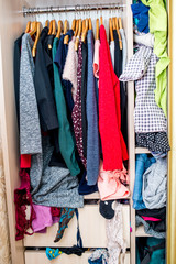 clothes sticking out of the closet. Second hand for recycling