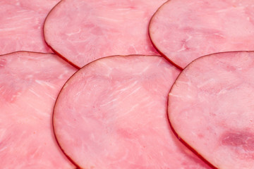 Sliced tasty ham background.