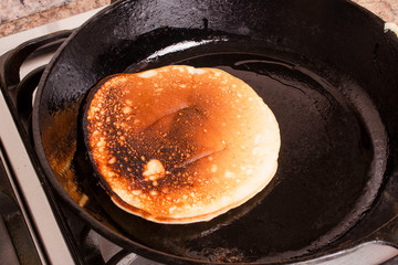 Close up of whole grain pancake on frying pan