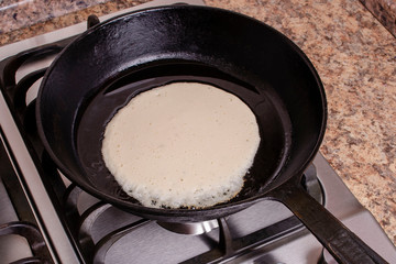 The process of cooking pancakes on a hot skillet