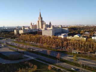 
Moscow State University from a height on a sunny day in classical architecture against a bright blue sky in Moscow