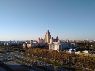 
Moscow State University from a height on a sunny day in classical architecture against a bright blue sky in Moscow