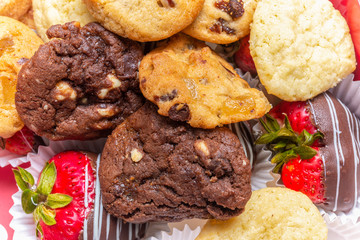 Homemade chocolate chip, macadamia and sugar cookies with chocolate covered strawberries