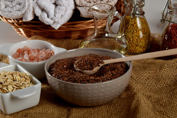 a bowl full of linseed in the company of other seeds for the production of homemade body cosmetics