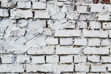 Beautiful white painted brick wall shabby old with cracks in the loft style with seams. Texture, background