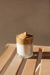 Dalgon coffee in the sunlight on a wooden bench