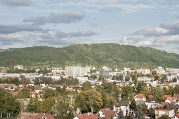 Fototapeta premium Sunrise and sunset, beautiful clouds over the meadow, hills and buildings in the town. Slovakia