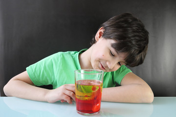 Niño realizando un experimento casero durante la cuarentena por coronavirus, es una lámpara de...