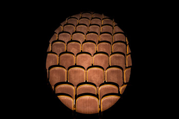 The hall is illuminated by a searchlight. A beam in the center of the concert hall, dark at the edges.