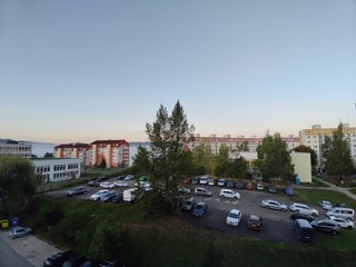 Sunrise and sunset, beautiful clouds over the meadow, hills and buildings in the town. Slovakia