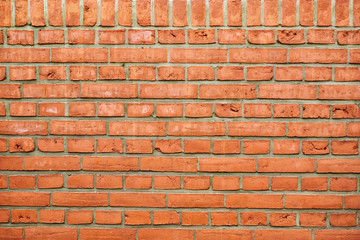 Beschaffenheit einer roten Ziegelsteinmauer mit grauen Zementfugen als abstrakter Hintergrund