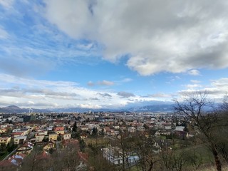 Sunrise and sunset, beautiful clouds over the meadow, hills and buildings in the town. Slovakia