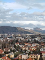 Sunrise and sunset, beautiful clouds over the meadow, hills and buildings in the town. Slovakia