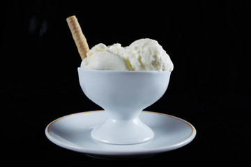 
ice cream, milk ice cream in bowl isolated on black background. white ice cream, turkish ice cream, summer flavors