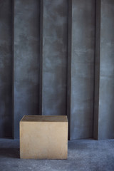 wooden cube on a background of a gray grunge wall for crossfit