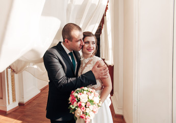 bride and groom on a light background