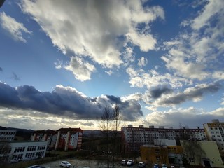Sunrise and sunset, beautiful clouds over the meadow, hills and buildings in the town. Slovakia