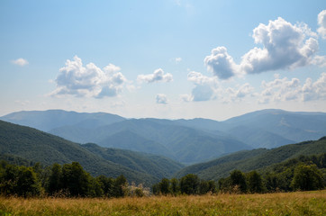 Picturesque summer landscape with forest slopes, mountain ranges and peaks in the Carpathians, Ukraine. Holidays in the mountains.