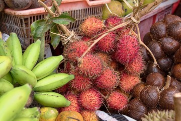 Tropical fruits at a market stall in an Asian market.
