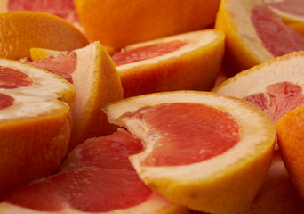 Fototapeta na wymiar Grapefruit web banner background. Pile of fresh cut grapefruits. Fruits summer bright concept