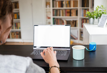 happy woman working on laptop in home office