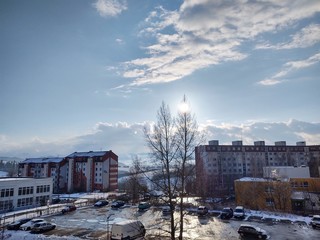 Sunrise and sunset, beautiful clouds over the meadow, hills and buildings in the town. Slovakia