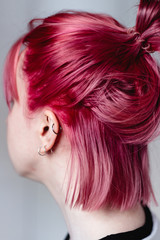 Woman with pink hair. The view from the back, the face is not visible.