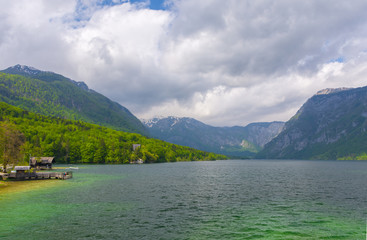 Clear blue water of lake Bohinj, Julian Alps, the largest permanent lake in Slovenia. Beautiful mountain landscape in spring.