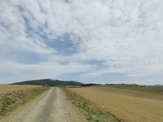 Sunrise and sunset, beautiful clouds over the meadow, hills and buildings in the town. Slovakia